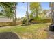 Landscaped backyard with seating area, lush lawn, and privacy fence at 2537 Thompson Ne Rd, Brookhaven, GA 30319