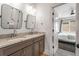 Modern bathroom with double vanity, granite counters, and a shower-tub combo behind a partial privacy curtain at 2537 Thompson Ne Rd, Brookhaven, GA 30319