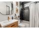 Stylish bathroom with modern fixtures, a wood vanity, and black and white decor at 2537 Thompson Ne Rd, Brookhaven, GA 30319