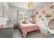 Charming bedroom featuring floral wallpaper, a stylish light fixture, and an inviting egg chair at 2537 Thompson Ne Rd, Brookhaven, GA 30319