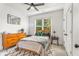 Comfortable bedroom with ceiling fan, large window and wooden furniture at 2537 Thompson Ne Rd, Brookhaven, GA 30319