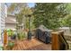 Outdoor deck perfect for grilling and entertaining, surrounded by trees and natural light at 2537 Thompson Ne Rd, Brookhaven, GA 30319
