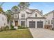 Charming two-story white brick home with a manicured lawn and a two-car garage at 2537 Thompson Ne Rd, Brookhaven, GA 30319
