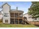 Home exterior showcasing the deck and screened porch with stairs at 2537 Thompson Ne Rd, Brookhaven, GA 30319