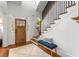 Welcoming foyer features hardwood floors, staircase, bench seating and a skylight at 2537 Thompson Ne Rd, Brookhaven, GA 30319