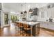 Stylish kitchen features quartz island with bar seating, stainless appliances, and designer lighting at 2537 Thompson Ne Rd, Brookhaven, GA 30319