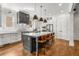 Modern kitchen design with center island and seating, white cabinets, stainless appliances, and hardwood floors at 2537 Thompson Ne Rd, Brookhaven, GA 30319