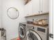 Functional laundry room with modern appliances and overhead storage at 2537 Thompson Ne Rd, Brookhaven, GA 30319