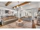 Open-concept living area with hardwood floors, modern lighting, and seamless flow to the kitchen at 2537 Thompson Ne Rd, Brookhaven, GA 30319