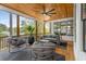 Relaxing screened porch featuring wood ceiling, ample seating, and a view of the surrounding greenery at 2537 Thompson Ne Rd, Brookhaven, GA 30319