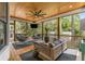 Relaxing screened porch with vaulted wood ceiling, ceiling fan, and comfortable outdoor seating at 2537 Thompson Ne Rd, Brookhaven, GA 30319