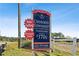 Community sign displaying 'Now Selling!' townhomes from the $370s in Cherokee Township at 432 Carrera Ln, Acworth, GA 30102