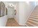 Inviting entryway featuring wood floors, a stylish mirror, and staircase at 432 Carrera Ln, Acworth, GA 30102
