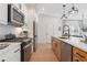 Modern kitchen with stainless steel appliances, white cabinets, and a functional island with a sink at 432 Carrera Ln, Acworth, GA 30102