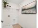 Neat laundry room with modern appliances, storage, and a stylish decor piece at 432 Carrera Ln, Acworth, GA 30102
