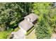 Aerial view of house showcasing shingled roof, lawn, driveway, and wooded surroundings at 4140 Westchester Ne Xing, Roswell, GA 30075
