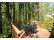 Relaxing outdoor deck featuring green metal table set and wooded surroundings at 4140 Westchester Ne Xing, Roswell, GA 30075