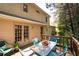 Relaxing outdoor deck featuring green metal table set and wooded surroundings at 4140 Westchester Ne Xing, Roswell, GA 30075
