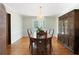 Elegant dining room featuring hardwood floors, a chandelier, a large wooden table with chairs, and a china cabinet at 4140 Westchester Ne Xing, Roswell, GA 30075