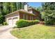 Red brick home featuring an attached two-car garage and mature landscaping at 4140 Westchester Ne Xing, Roswell, GA 30075