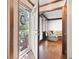 Bright foyer with hardwood floors, white trim, and a glimpse into a cozy living space through an open door at 4140 Westchester Ne Xing, Roswell, GA 30075