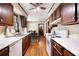 Galley kitchen featuring hardwood floors, oak cabinets, white appliances, and a view to the dining room at 4140 Westchester Ne Xing, Roswell, GA 30075