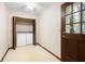 Laundry room featuring a door to the outside, tile floors, and bi-fold doors enclosing washer and dryer at 4140 Westchester Ne Xing, Roswell, GA 30075
