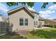 Exterior view showcasing the home's architecture, patio, and spacious backyard at 5450 Fieldfreen Dr, Cumming, GA 30028