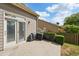 Back patio with slider door access, grill, and manicured hedge in a fenced in yard at 5450 Fieldfreen Dr, Cumming, GA 30028