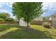 A backyard featuring a storage shed, privacy fence, and mature landscaping at 5450 Fieldfreen Dr, Cumming, GA 30028
