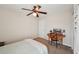 Cozy bedroom featuring a ceiling fan, drop leaf table, and neutral decor at 5450 Fieldfreen Dr, Cumming, GA 30028