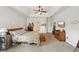 Spacious bedroom with tray ceiling, carpet floors, wooden accents, and lots of natural light at 5450 Fieldfreen Dr, Cumming, GA 30028
