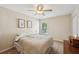 Inviting bedroom featuring a ceiling fan and a bright window offering ample natural light at 5450 Fieldfreen Dr, Cumming, GA 30028
