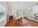 Breakfast nook with fireplace, hardwood floors, and ample natural light from a large window at 5450 Fieldfreen Dr, Cumming, GA 30028