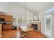 Inviting breakfast nook with a fireplace, hardwood floors, and a view to the kitchen at 5450 Fieldfreen Dr, Cumming, GA 30028