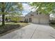 Beautiful brick home featuring a two-car garage and landscaped front yard at 5450 Fieldfreen Dr, Cumming, GA 30028