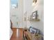 Bright entryway features hardwood floors, a tall window letting in natural light, and a charming decorative shelf at 5450 Fieldfreen Dr, Cumming, GA 30028