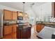 Well-lit kitchen boasts stainless steel appliances, granite countertops, and wooden cabinetry at 5450 Fieldfreen Dr, Cumming, GA 30028