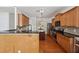 Well-lit kitchen features a central island, stainless steel appliances, and wooden cabinetry at 5450 Fieldfreen Dr, Cumming, GA 30028