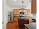 Well-lit kitchen boasts stainless steel appliances, granite countertops, and wooden cabinetry at 5450 Fieldfreen Dr, Cumming, GA 30028