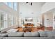 Bright open living space with a vaulted ceiling, large windows, hardwood floors, and comfortable seating at 5450 Fieldfreen Dr, Cumming, GA 30028