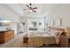 Spacious main bedroom with tray ceiling, ceiling fan, and adjoining sunroom at 5450 Fieldfreen Dr, Cumming, GA 30028