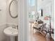 Bright powder room with modern fixtures and pedestal sink at 5450 Fieldfreen Dr, Cumming, GA 30028