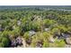 Wide aerial view showcasing property with mature trees, pool, and the surrounding neighborhood at 629 Concord Sw Rd, Smyrna, GA 30082