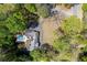 Beautiful aerial view of a home with a private pool, patio, and lush landscaping, surrounded by mature trees at 629 Concord Sw Rd, Smyrna, GA 30082