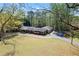 Aerial view of house with a long driveway, lush lawn, and mature trees at 629 Concord Sw Rd, Smyrna, GA 30082