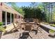 Paver patio with a hot tub, outdoor chairs and bench seating in a fenced backyard with mature trees at 629 Concord Sw Rd, Smyrna, GA 30082