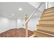Finished basement with wood-look floors leading to stairs and door, and neutral color palette at 629 Concord Sw Rd, Smyrna, GA 30082