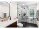 Bathroom featuring vanity with marble countertop, glass shower, modern fixtures, and a window at 629 Concord Sw Rd, Smyrna, GA 30082
