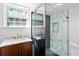 Modern bathroom featuring a glass-enclosed shower, marble-look tile, and stylish vanity with brass fixtures at 629 Concord Sw Rd, Smyrna, GA 30082